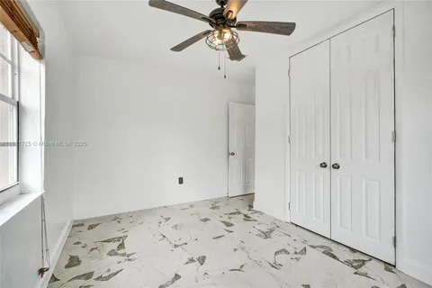 a front view of a house with a garden and yard