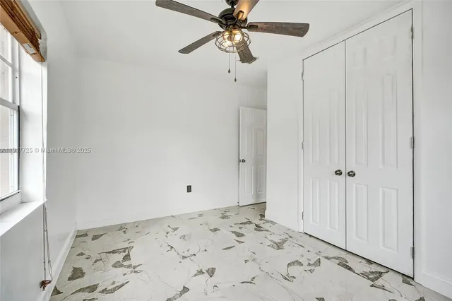 a front view of a house with a garden and yard