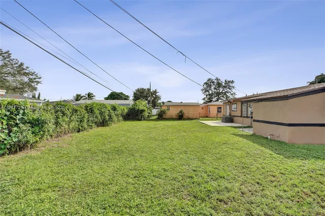 a view of a garden with a building in the background