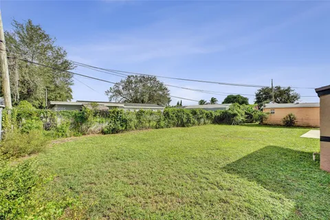 a view of a garden with a house in the background