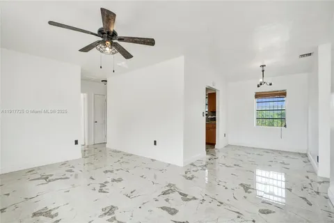 a view of a room with a empty space and wooden floor