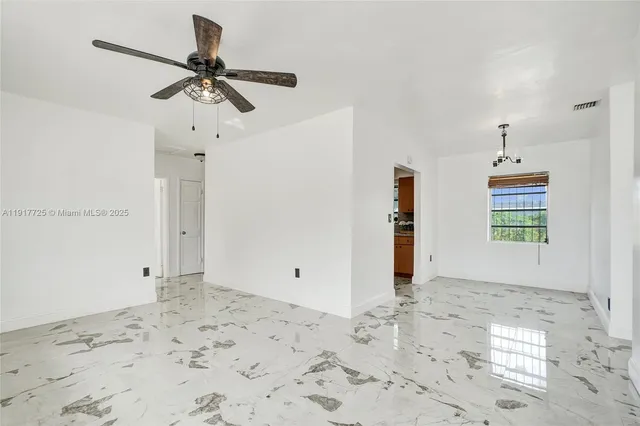 a view of a room with a empty space and wooden floor