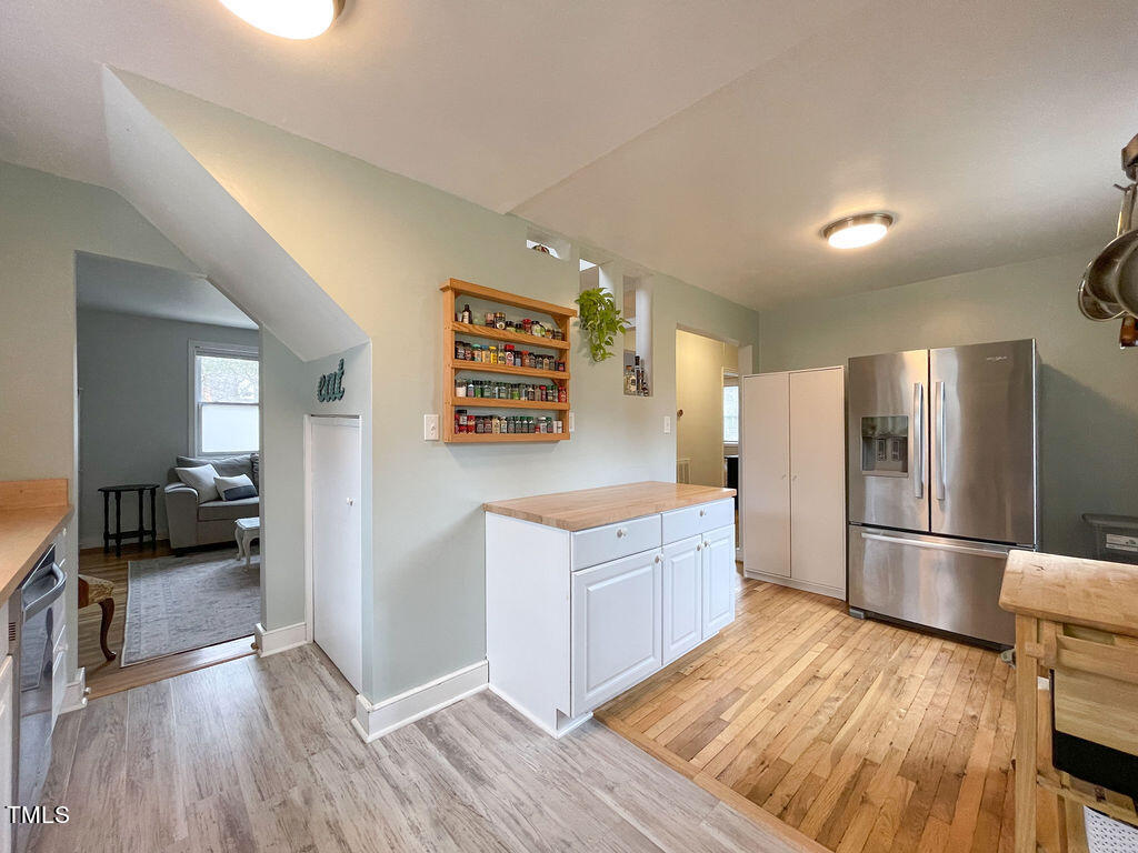 301 Colleton Road Raleigh, NC 27610 - Photo 5 of 14 a kitchen with stainless steel appliances a refrigerator and wooden floor