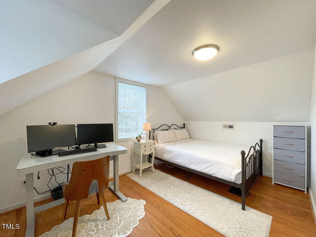 301 Colleton Road Raleigh, NC 27610 - Photo 10 of 14 a bedroom with a bed and a flat screen tv