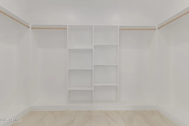 a bathroom with double vanity and a mirror