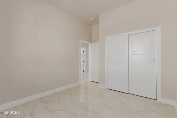 an empty room with ceiling fan and window