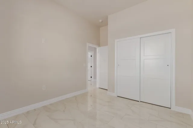 an empty room with ceiling fan and window