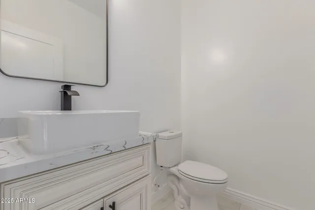 a view of a hallway with wooden floor and a rug