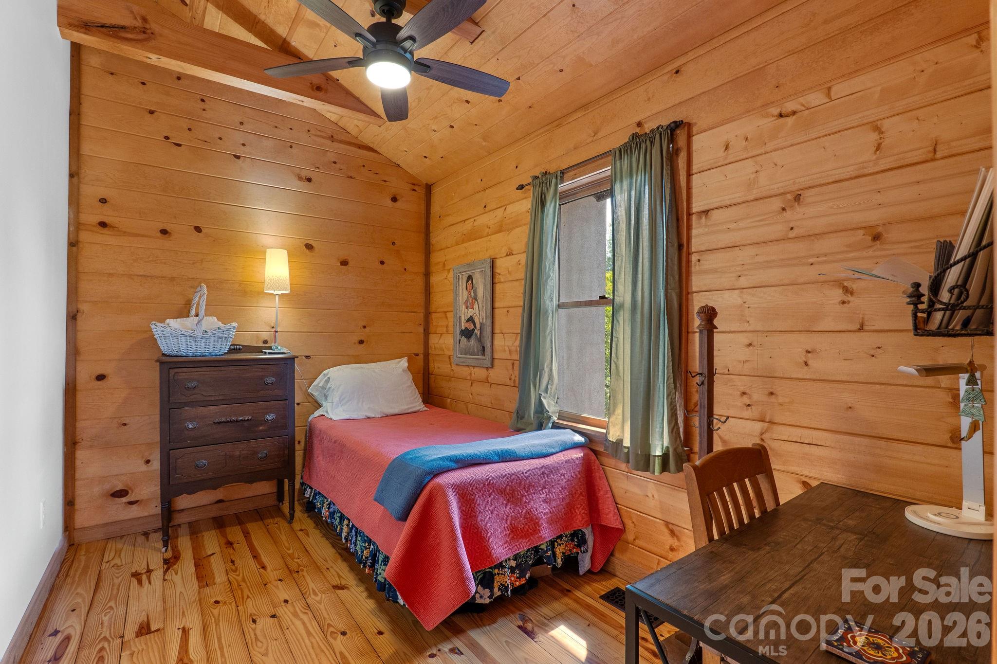 150 Avondale Ridge Road Asheville, NC 28803 - Photo 30 of 45 a bedroom with a bed and wooden floor