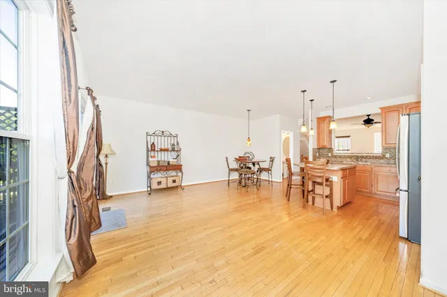 a view of a living room filled with furniture and a kitchen view