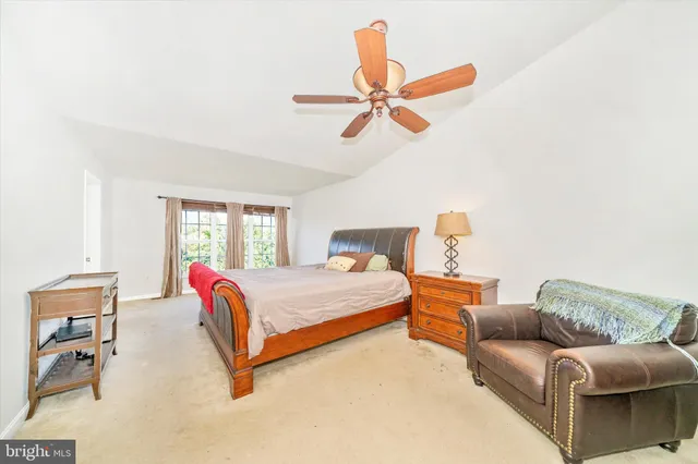 a bedroom with a bed couch and window