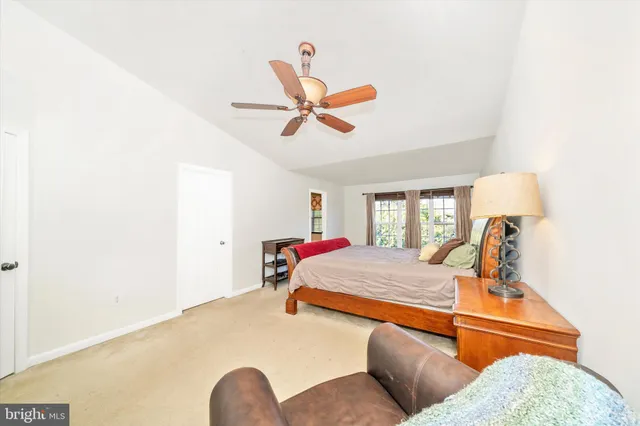 a bedroom with a bed and dresser with mirror