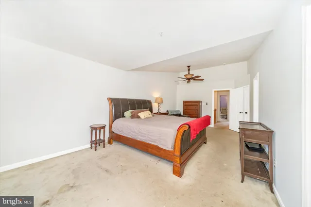 a bedroom with a bed dresser and a chair