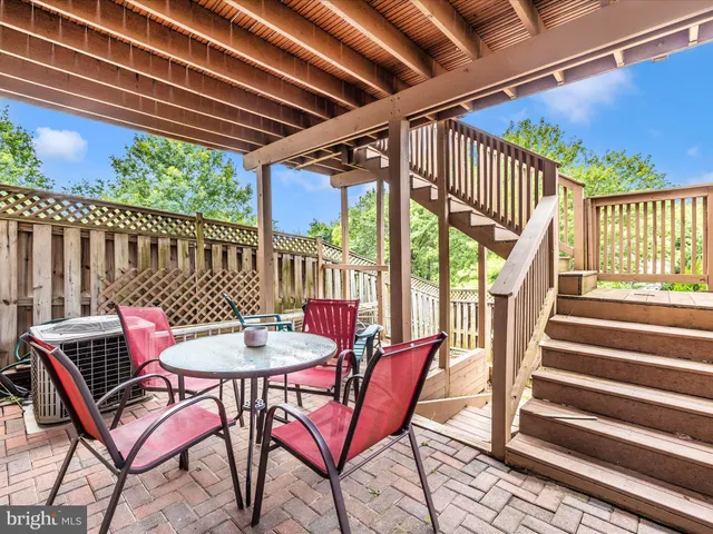 a view of a chairs and table in the balcony