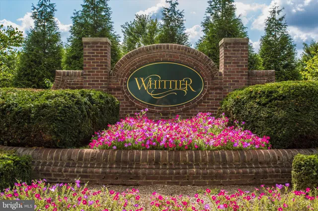 a sign that is sitting in front of flowers