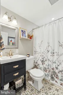 a bathroom with a toilet sink and mirror