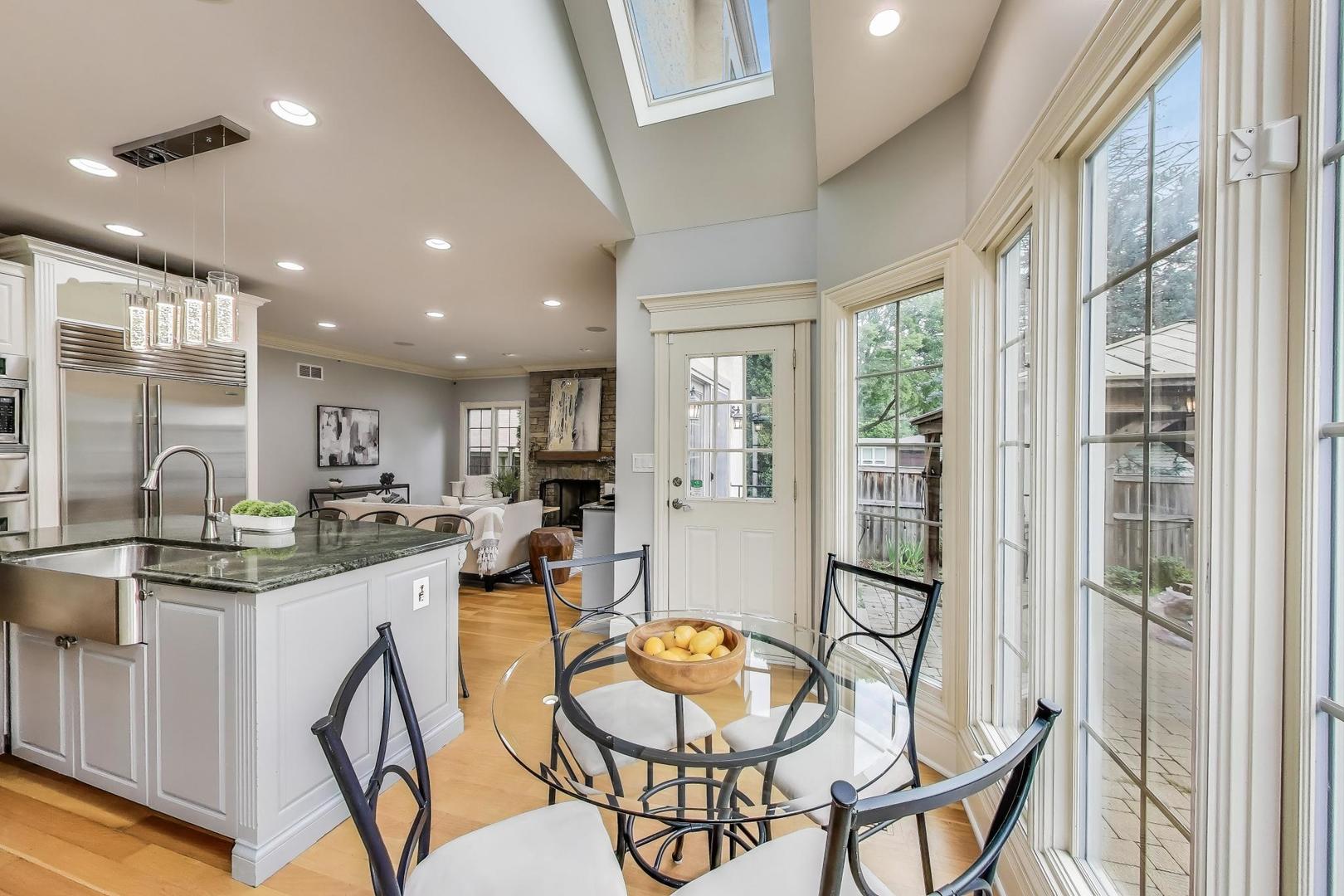 621 North County Line Road Hinsdale, IL 60521 - Photo 16 of 59 a kitchen with stainless steel appliances granite countertop dining table chairs and wooden floor