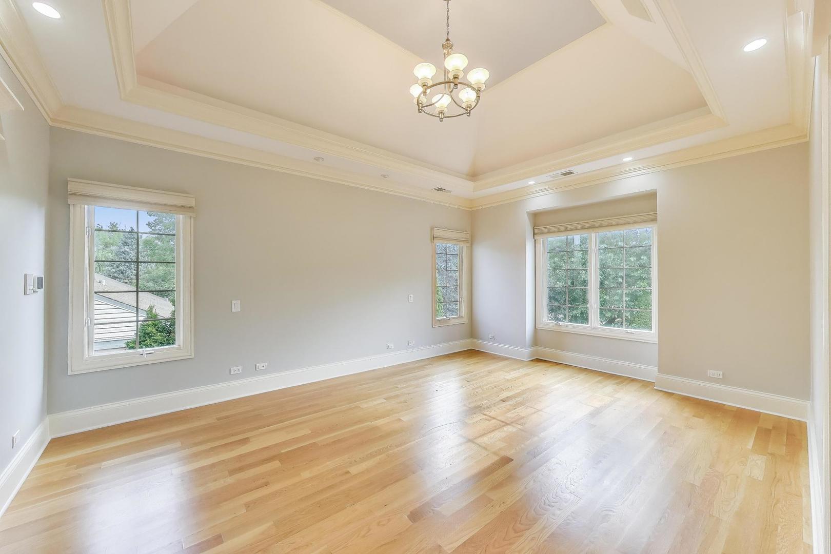 621 North County Line Road Hinsdale, IL 60521 - Photo 25 of 59 a view of an empty room with a window and wooden floor