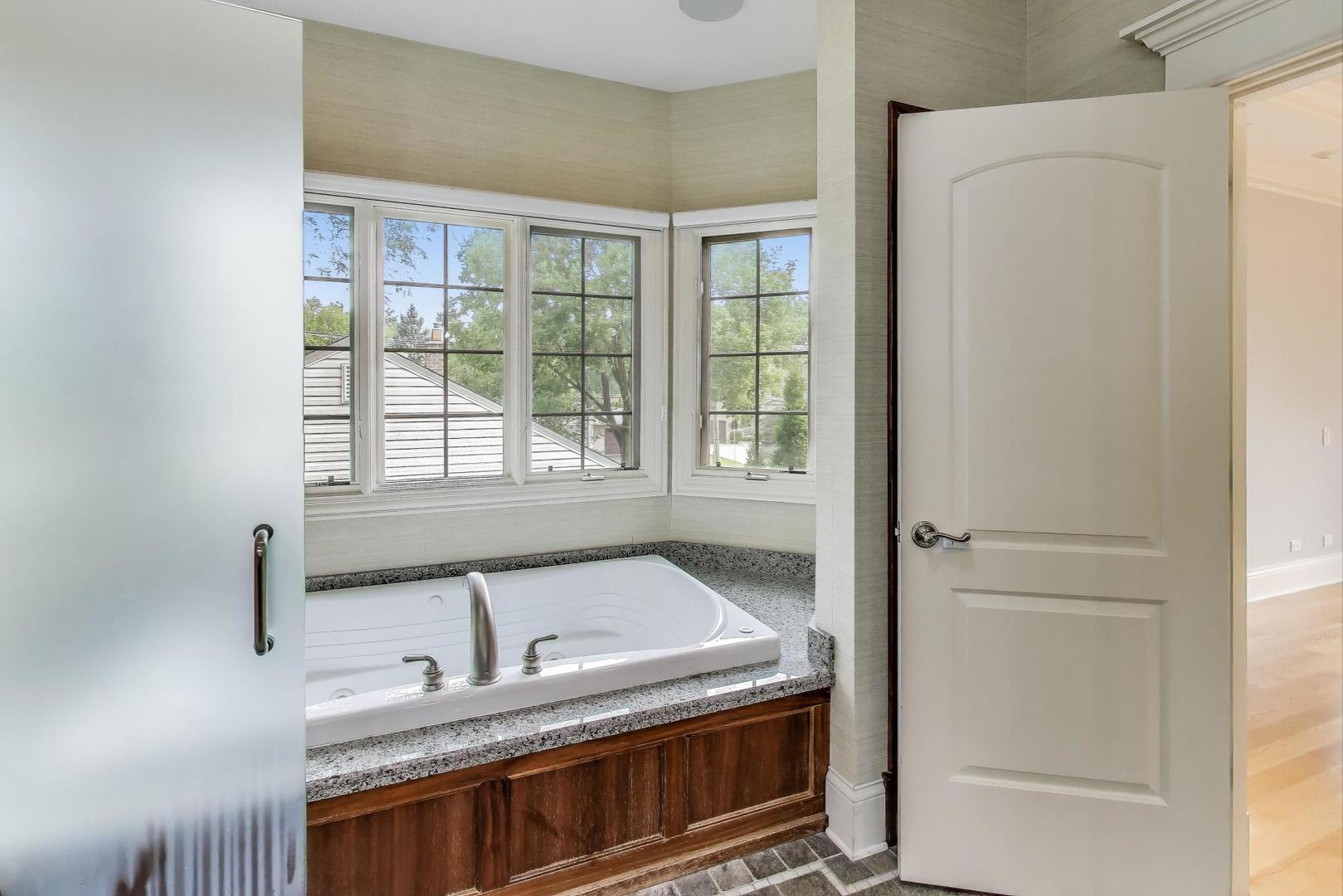 621 North County Line Road Hinsdale, IL 60521 - Photo 32 of 59 a bathroom with a granite countertop sink and a bathtub