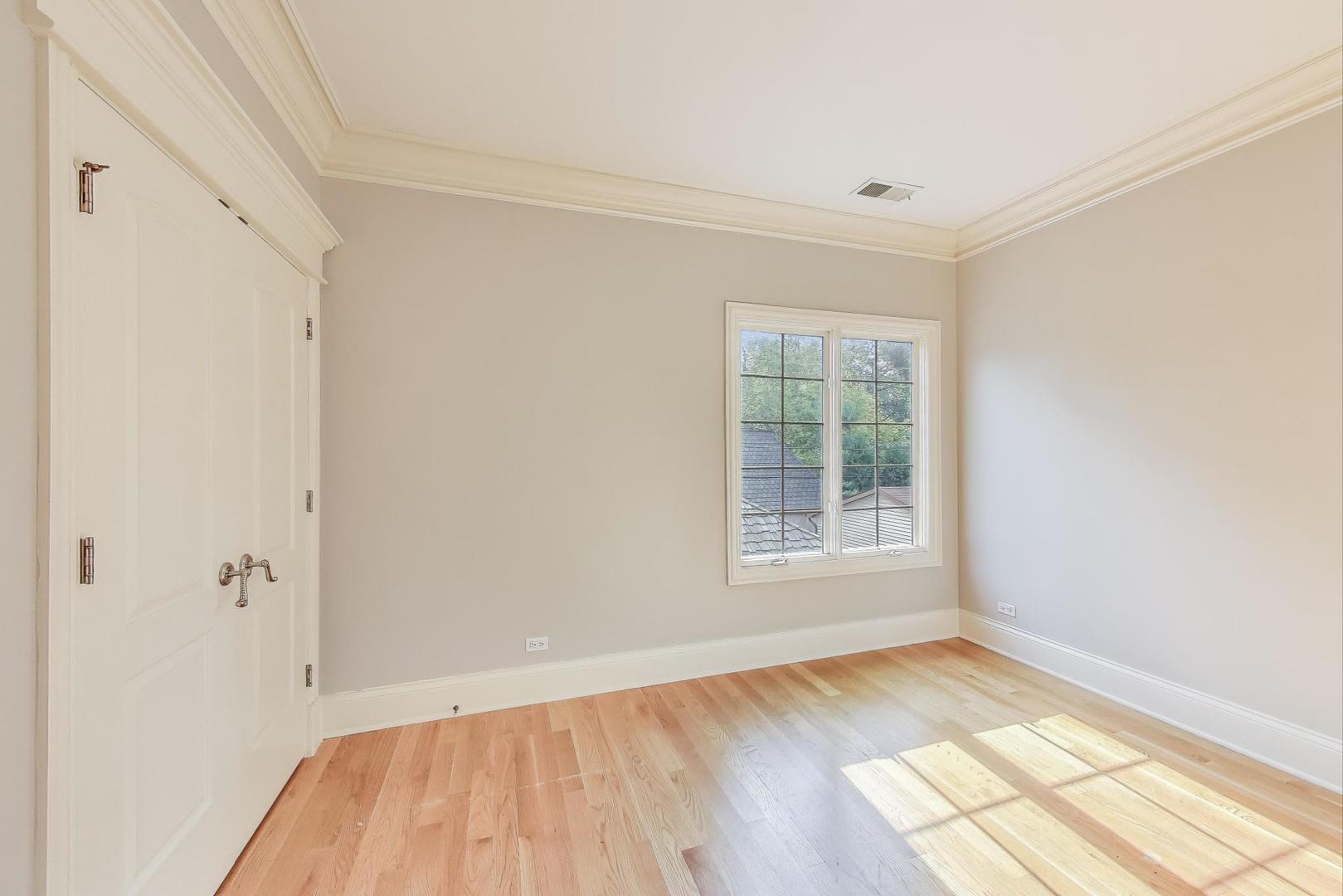 621 North County Line Road Hinsdale, IL 60521 - Photo 37 of 59 a view of empty room with wooden floor and fan