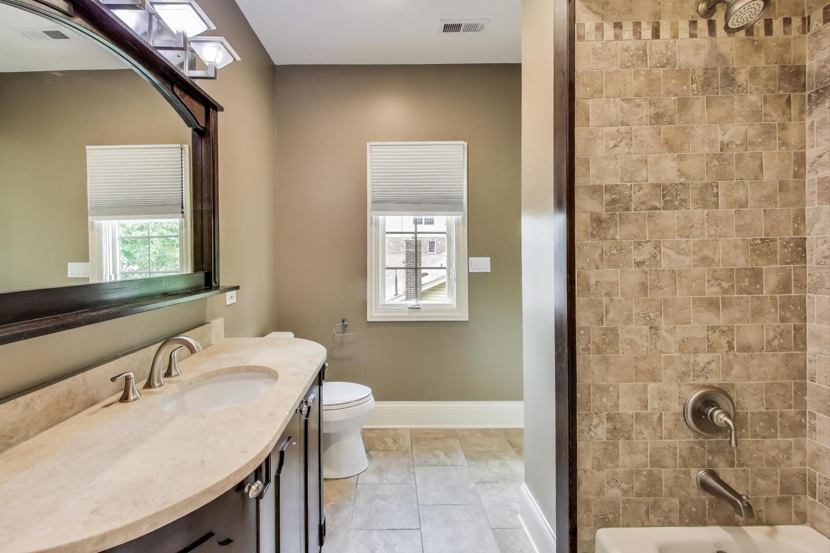 621 North County Line Road Hinsdale, IL 60521 - Photo 40 of 59 a bathroom with a granite countertop sink a toilet and shower