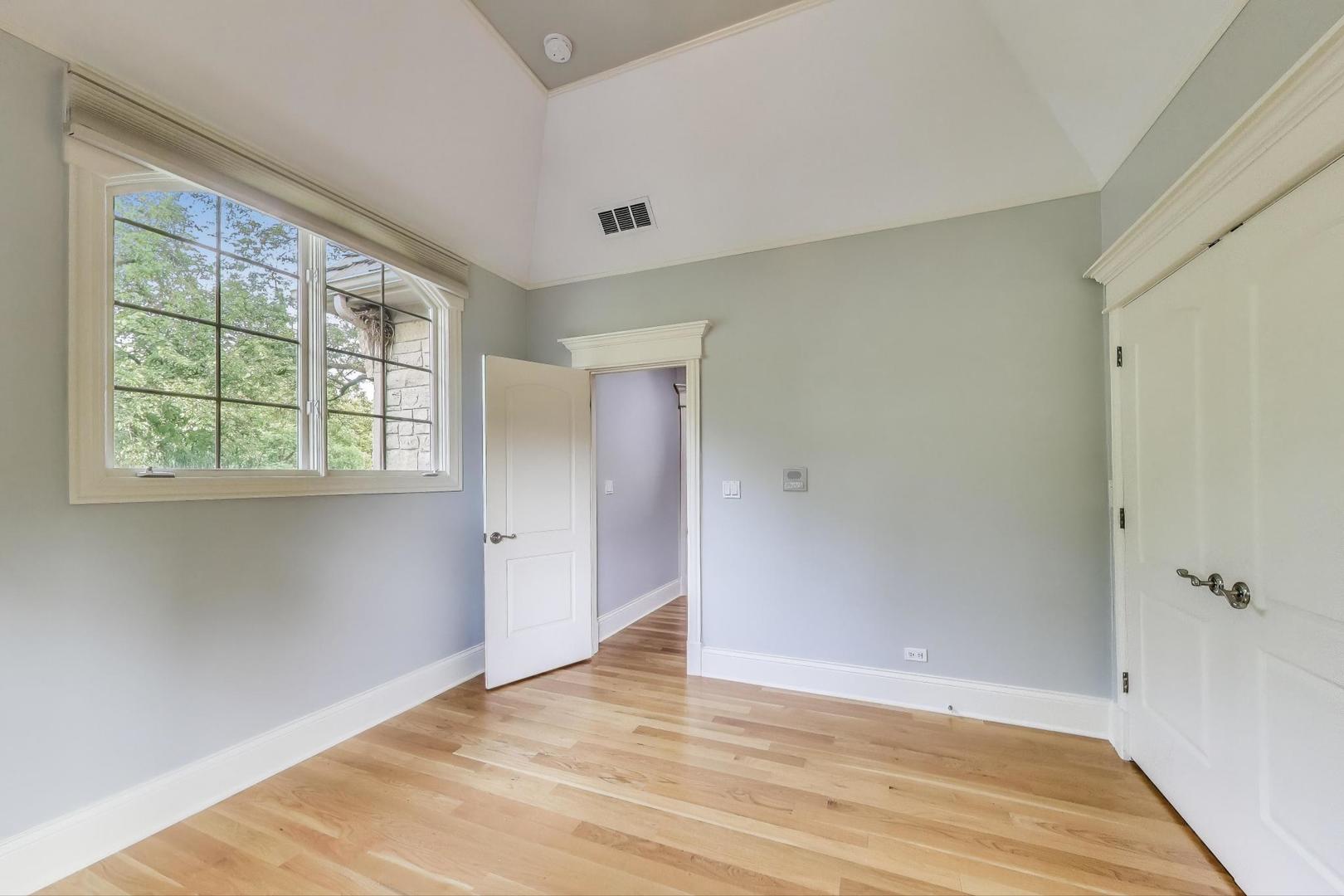 621 North County Line Road Hinsdale, IL 60521 - Photo 41 of 59 a view of an empty room with wooden floor and a window