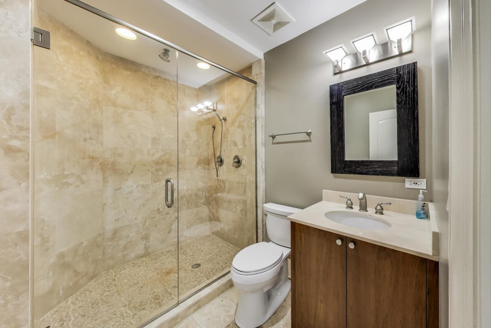 621 North County Line Road Hinsdale, IL 60521 - Photo 54 of 59 a bathroom with a sink vanity mirror and toilet