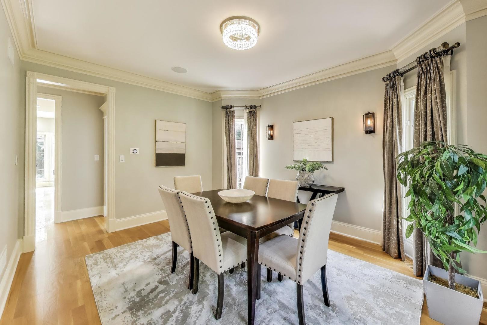 621 North County Line Road Hinsdale, IL 60521 - Photo 9 of 59 a view of a dining room with furniture and a potted plant