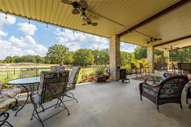 a view of swimming pool with outdoor seating and plants