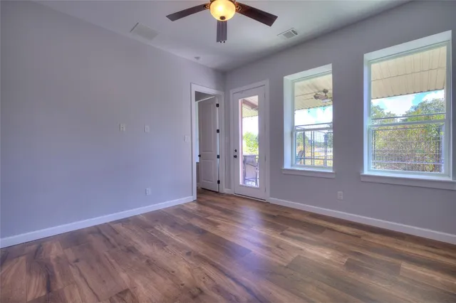 wooden floor in an empty room with a window