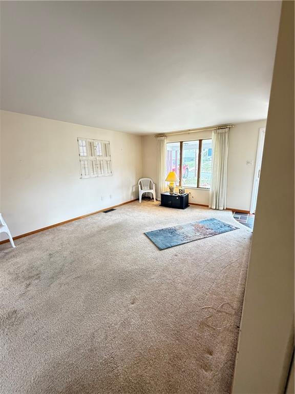432 Violet Drive Lower Burrell, PA 15068 - Photo 13 of 42 an empty room with a fireplace and a window