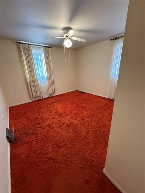 432 Violet Drive Lower Burrell, PA 15068 - Photo 17 of 42 a view of a room with a ceiling fan and wooden floor