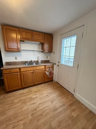 a large kitchen with a sink and dishwasher a microwave oven