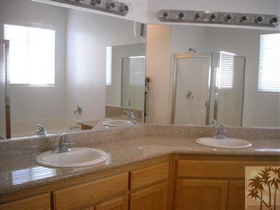 49829 Wayne Street Indio, CA 92201 - Photo 20 of 24 a bathroom with a granite countertop sink and a mirror
