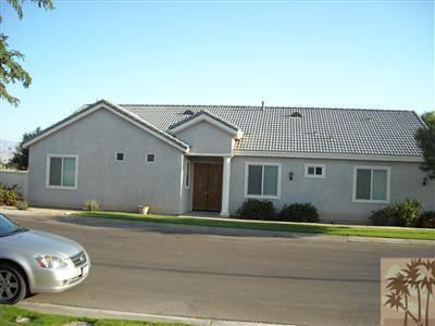 49829 Wayne Street Indio, CA 92201 - Photo 3 of 24 a front view of a house with garden
