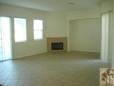 49829 Wayne Street Indio, CA 92201 - Photo 6 of 24 a view of an empty room with a fireplace and a window