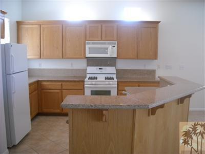 49829 Wayne Street Indio, CA 92201 - Photo 9 of 24 a kitchen with granite countertop cabinets and window