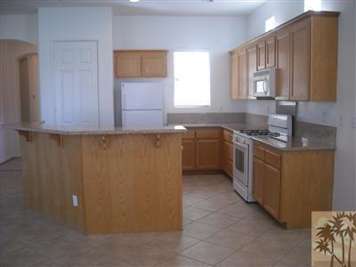 49829 Wayne Street Indio, CA 92201 - Photo 10 of 24 a kitchen with stainless steel appliances granite countertop a sink stove and cabinets