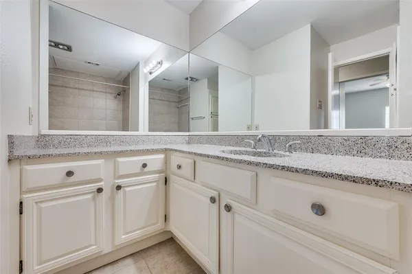 a sink with white cabinets