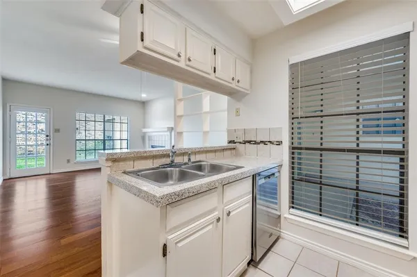 a kitchen with a sink cabinets and appliances