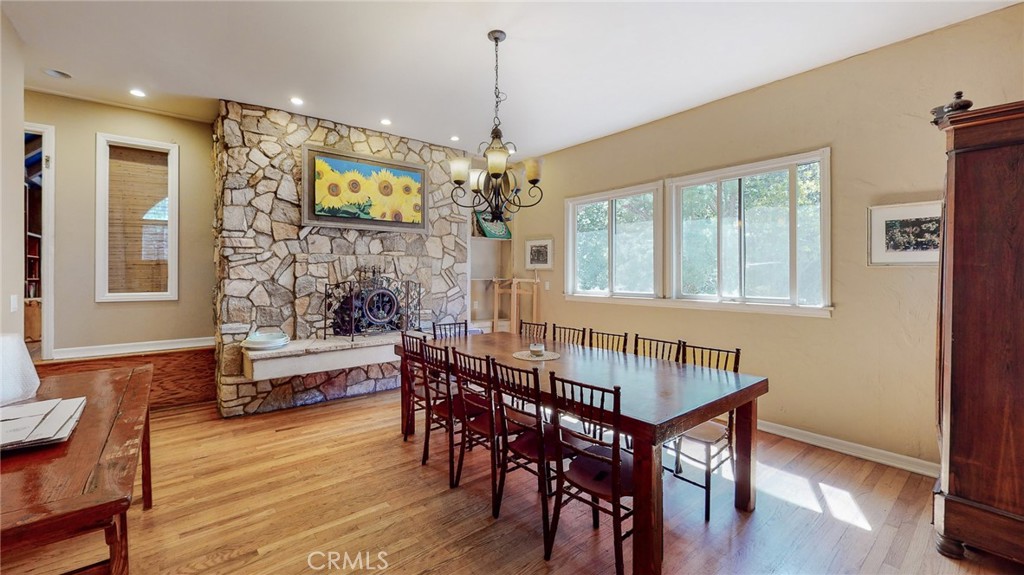 1248 Rocky Road Simi Valley, CA 93063 - Photo 11 of 71 a dining room with wooden floor a chandelier a wooden table and chairs