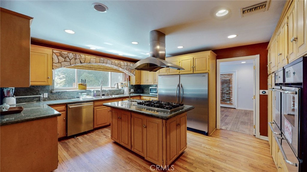 1248 Rocky Road Simi Valley, CA 93063 - Photo 13 of 71 a kitchen with stainless steel appliances granite countertop wooden floors and sink