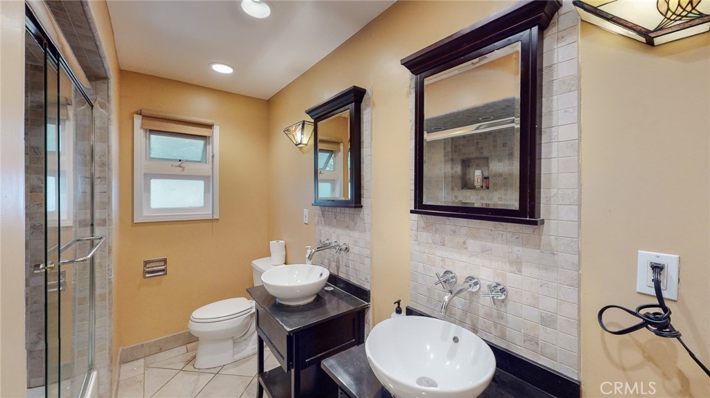1248 Rocky Road Simi Valley, CA 93063 - Photo 17 of 55 a bathroom with a toilet a sink and mirror