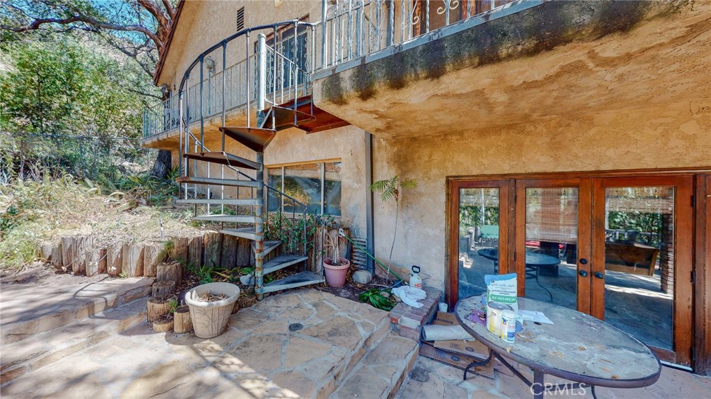 1248 Rocky Road Simi Valley, CA 93063 - Photo 37 of 71 a view of a patio with table and chairs potted plants with wooden floor