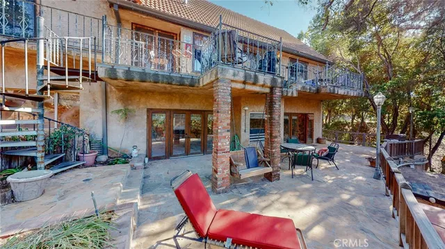 a view of a backyard of the house along with lots of green space and fountain