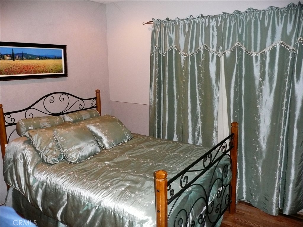 1248 Rocky Road Simi Valley, CA 93063 - Photo 68 of 71 a bedroom with a bed and a painting on the wall