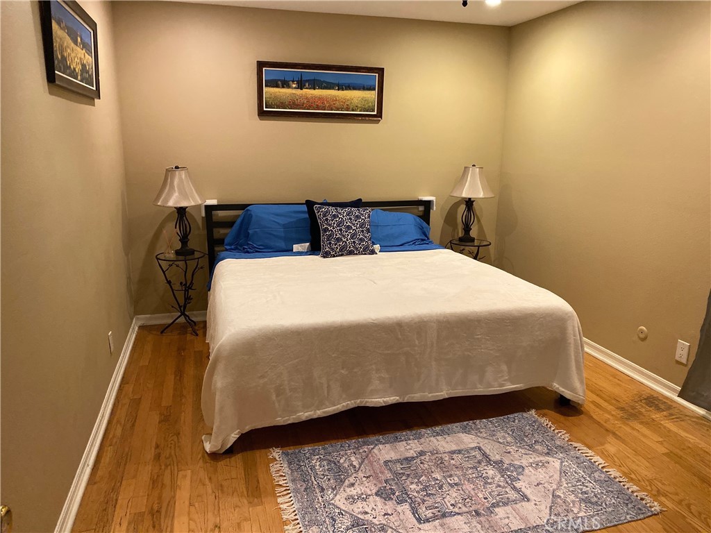 1248 Rocky Road Simi Valley, CA 93063 - Photo 71 of 71 a bedroom with a bed and wooden floor