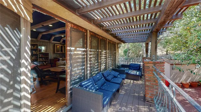 a dining room with wooden floor a chandelier a wooden table and chairs