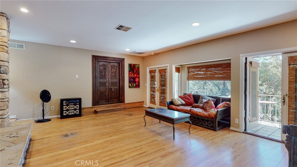 1248 Rocky Road Simi Valley, CA 93063 - Photo 10 of 71 a living room with furniture a flat screen tv and a large window