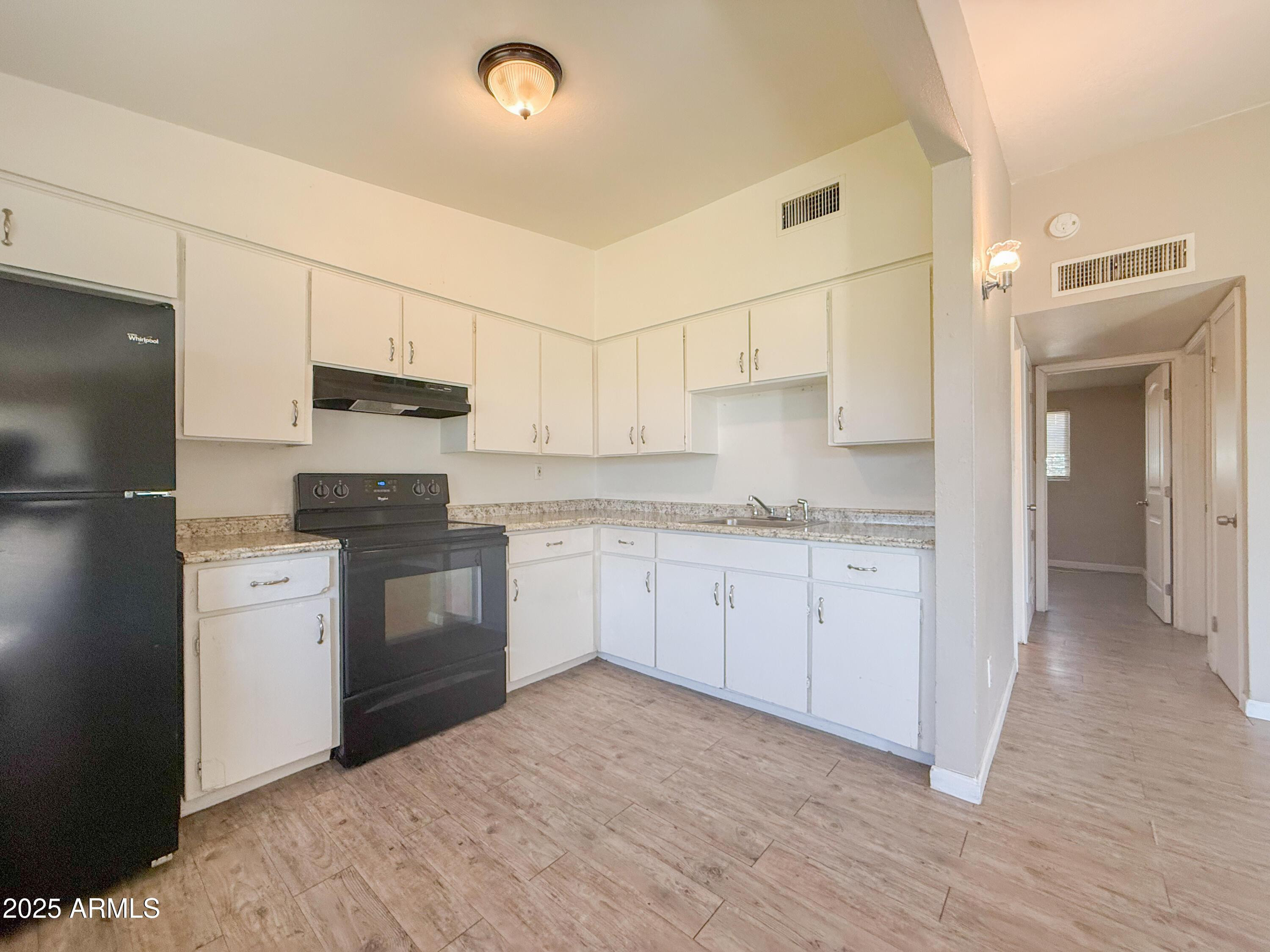 2123 West Devonshire Avenue, Unit 15 Phoenix, AZ 85015 - Photo 7 of 14 a kitchen with a refrigerator stove and sink